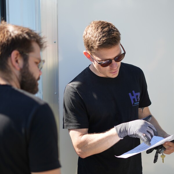 Techniciens se référant à un plan de distriution électrique avant l'implantation d'un événement.