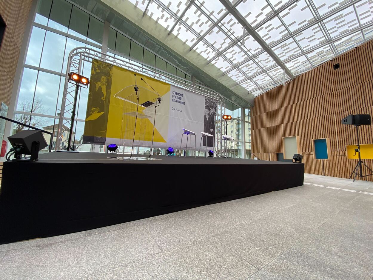 Scène avec jupe, moquette et arche en structure pour une remise de diplômes.